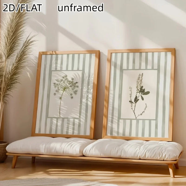 A set of two unframed canvas prints featuring sage green floral designs displayed on a wooden bench.