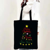 Black tote bag featuring a festive design with 'Merry Christmas and Happy New Year' text and stars.