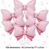 A pack of six pink bow balloons used for party decorations.