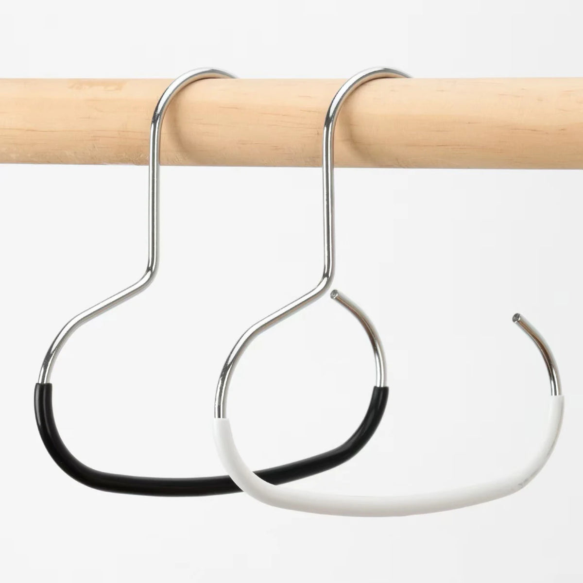 A silver circle ring hat hanger is shown hanging from a wooden rod.