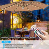A patio umbrella light with a remote control is shown illuminating an outdoor dining area at night.
