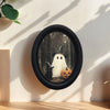 Vintage Halloween wall art featuring a ghost and a black cat silhouette framed in black