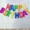 A string of thirteen rose gold foil letter balloons spelling out HAPPY BIRTHDAY decoration set.