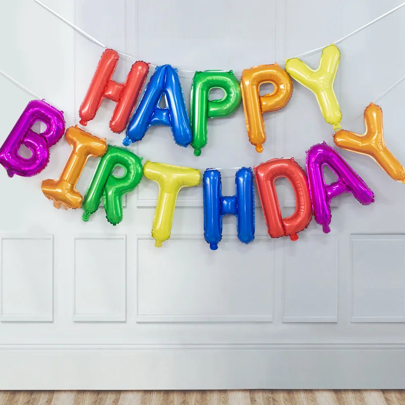A string of thirteen rose gold foil letter balloons spelling out HAPPY BIRTHDAY decoration set.