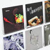 A display shelf featuring several acrylic vinyl record displays with album covers.