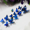A collection of twelve blue and black butterfly stickers arranged diagonally on a white surface.