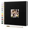 Black linen cover scrapbook album with gold-edged photo pages and a silver pen.