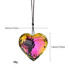 A heart-shaped pendant made of iridescent, rainbow-colored glass, suspended by a black cord.