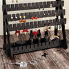 A black wooden earring organizer rack displaying various dangle and stud earrings.