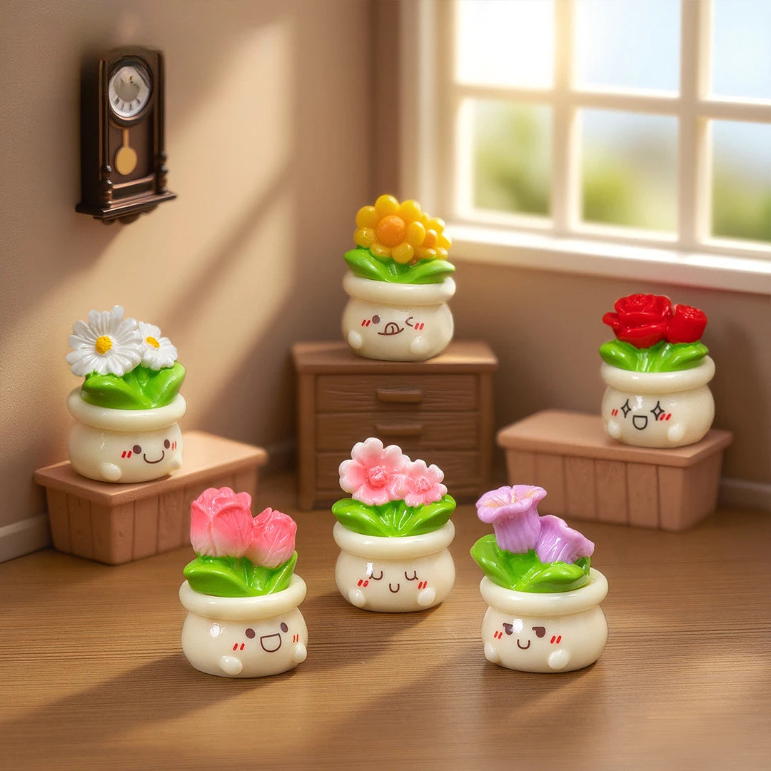 A collection of mini potted rose resin charms in various colors like yellow, green, and pink, displayed on a wooden surface.