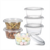 A collection of clear plastic sauce cups with lids, including small jars of dried fruit and a container of colorful pills.