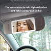 A car sun visor vanity mirror with an LED light is shown inside a vehicle cabin.