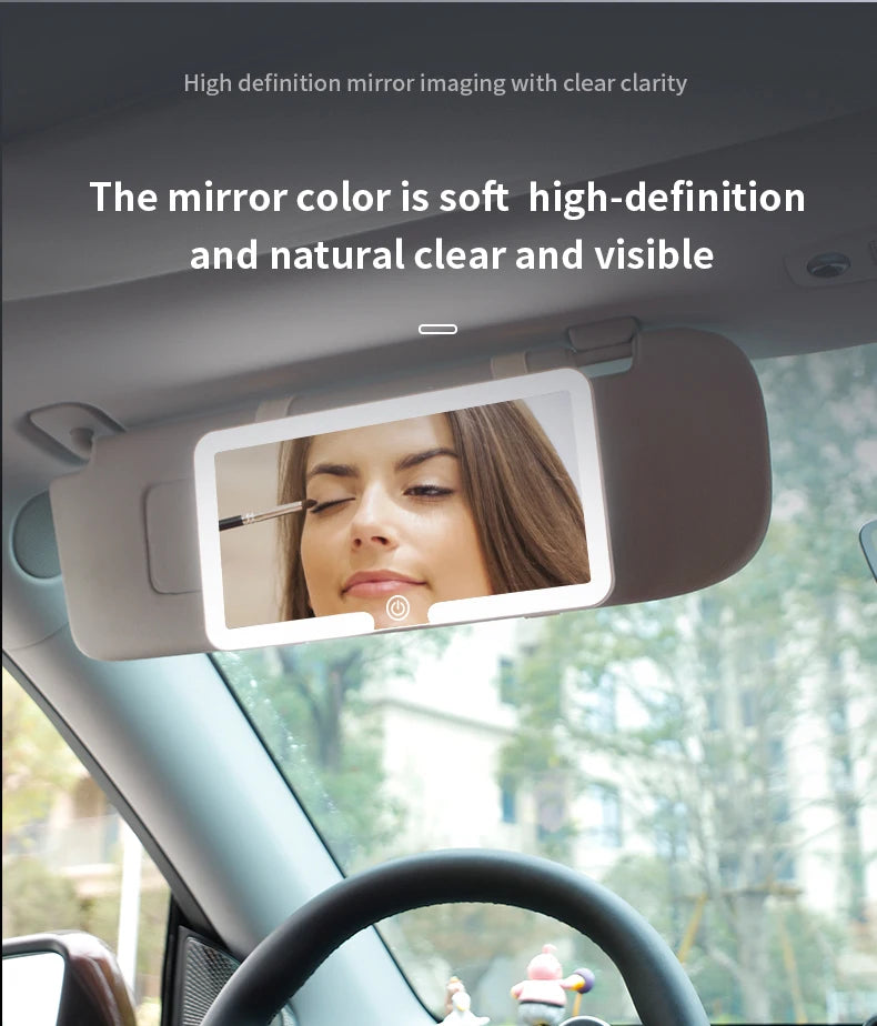 A car sun visor vanity mirror with an LED light is shown inside a vehicle cabin.