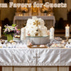 A display of mini baptism favors featuring rosaries and crosses in various styles, set on a white table.