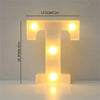 A glowing letter T made of LED lights, used for cozy room or party decor.