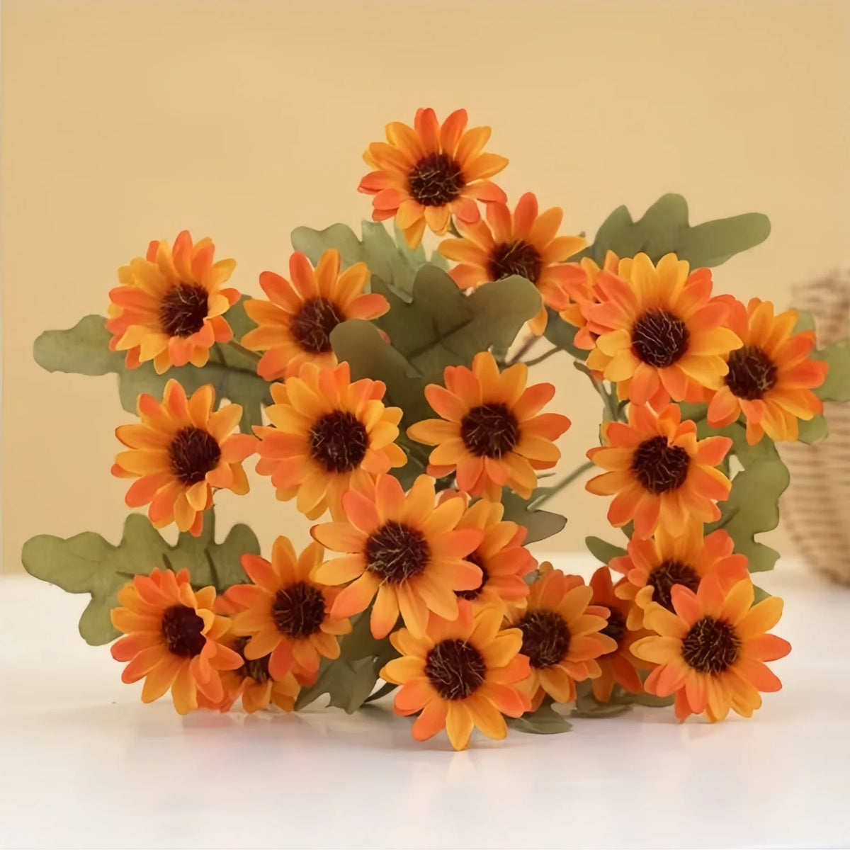 A bouquet of three lifelike silk gerbera daisy artificial flowers in shades of orange and yellow.