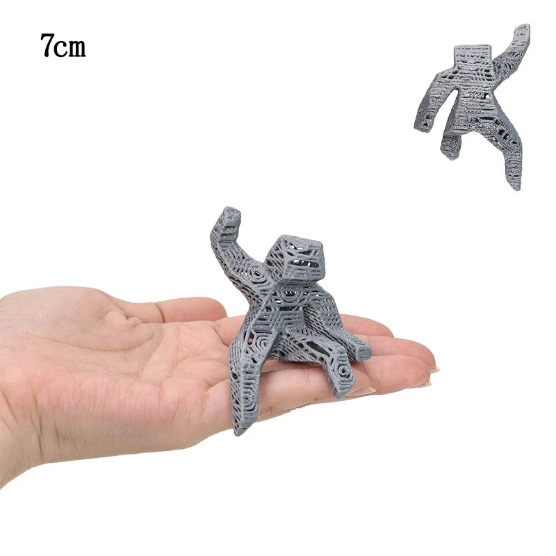 A gray collectible figurine set shaped like Rocky and Grace, shown in a hand for scale.