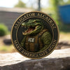 A round collectible coin featuring an alligator head and the text Alligator Alcatraz Make America Safe Again.