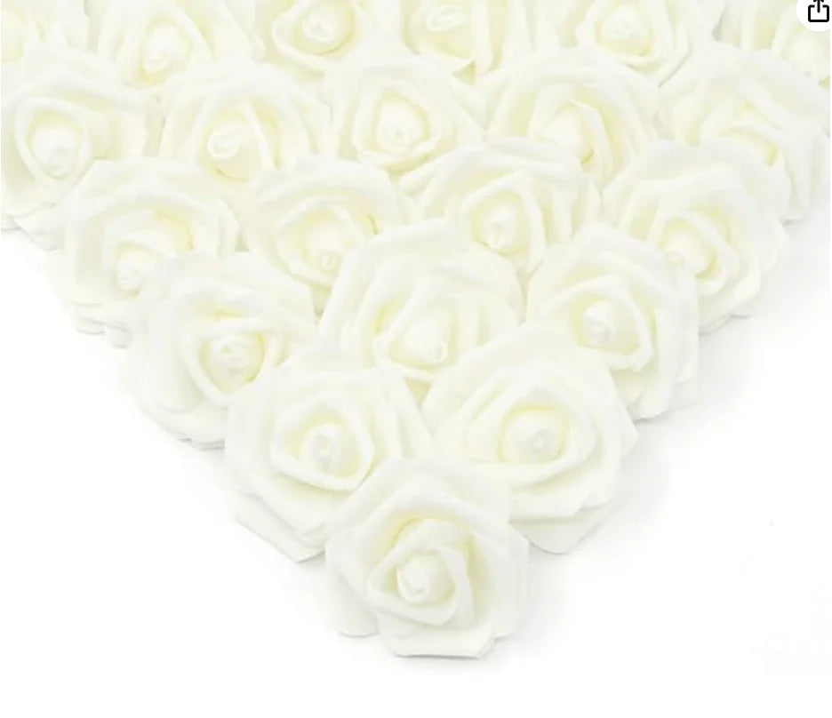 A heart shape made of white artificial foam rose decorations.