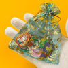 A clear mesh bag filled with Mexico style PVC shoe charms for sneakers, featuring colorful designs and gold accents.