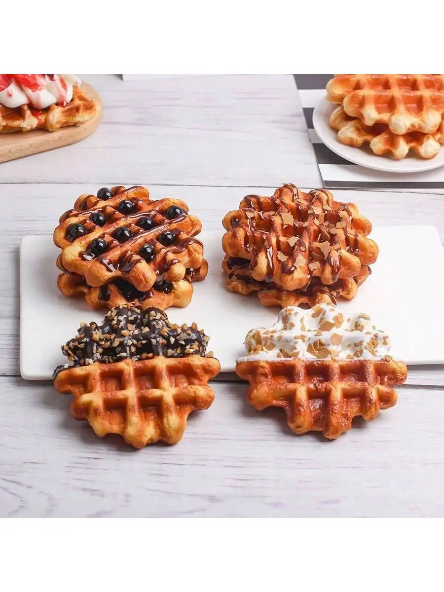 A display of various waffle foods including blueberry waffles, syrup-drizzled waffles, and waffles topped with whipped cream.