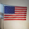 A decorative banner displaying the flag of the United States of America hanging on a wall.