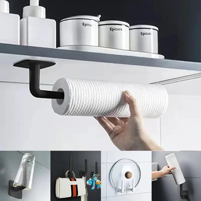 A hand holds a white roll of adhesive cap holder hooks for wall mounted hat storage against a white shelf.