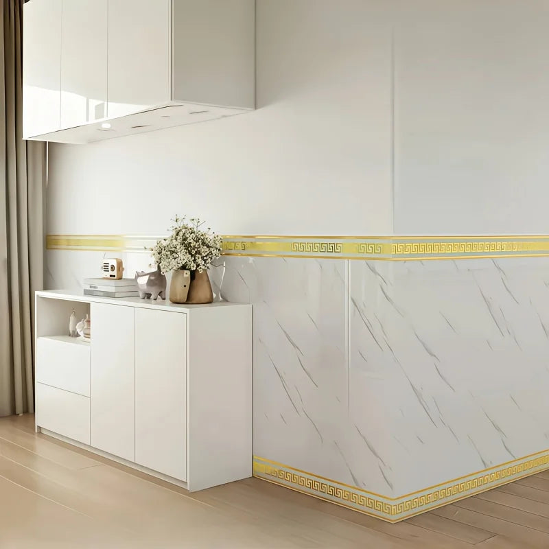 White kitchen cabinetry featuring a self-adhesive PVC baseboard trim with a brick pattern and gold accent.