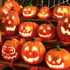 A collection of glowing orange Halloween pumpkins and lanterns displayed on a wooden shelf.