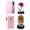 A pink rose in a glass dome with an LED light, presented in packaging.