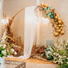 White sheer tulle draping fabric used as a backdrop for a wedding arch display