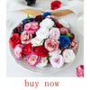 A platter of realistic silk rose flowers in various shades of pink, red, white, and blue.