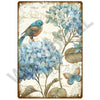 Vintage metal sign featuring a watercolor illustration of blue flowers and a butterfly on a rustic background.