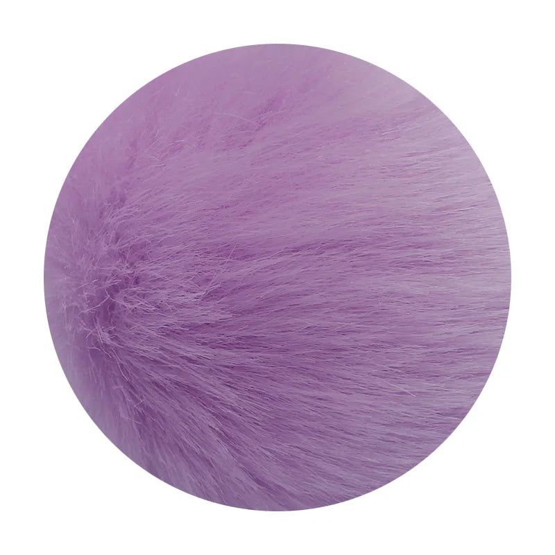 A round pom pom made of soft purple faux fur with a silver chain attached.
