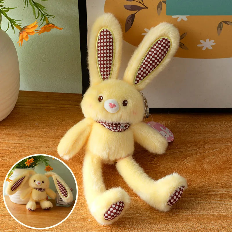 A yellow giant kawaii rabbit plush toy with long ears and a decorative collar sitting on a wooden surface.