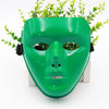 A bright green, face-shaped masquerade mask with a smooth finish and black straps is displayed on a white surface.