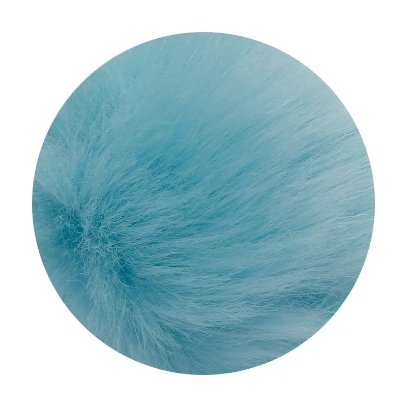 A round pom pom made of light blue faux fur with a silver chain.