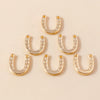 A collection of gold horse charm pendants for handmade jewelry displayed on a light background.