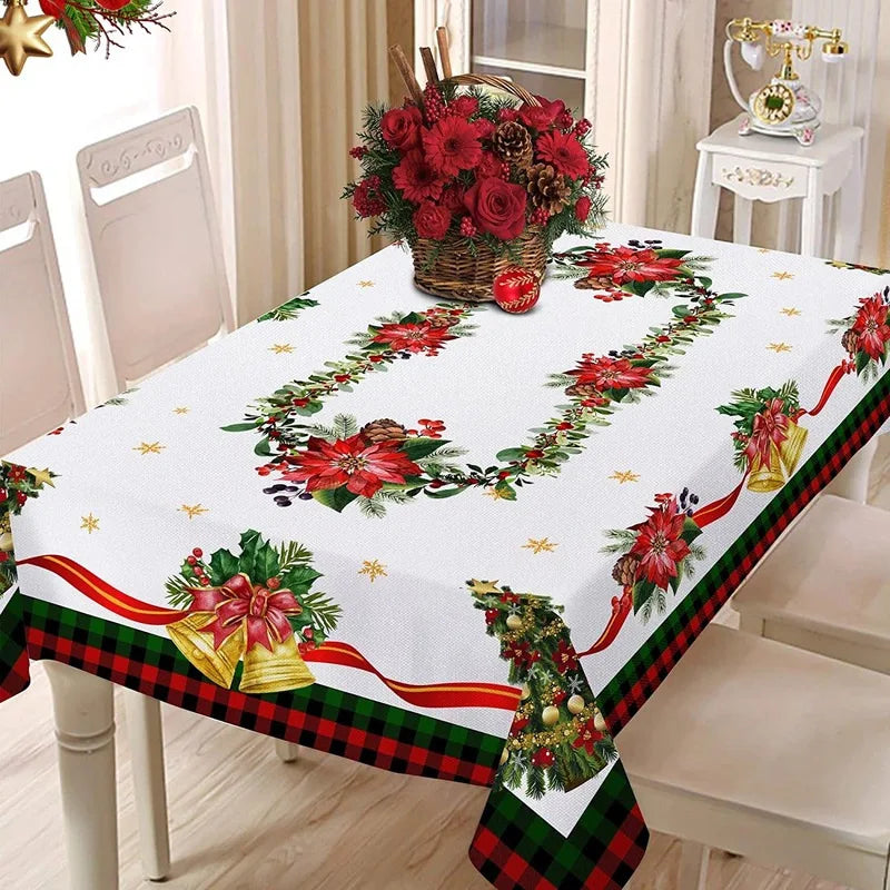 A festive red Christmas tablecloth featuring floral wreaths and plaid trim on a dining table.