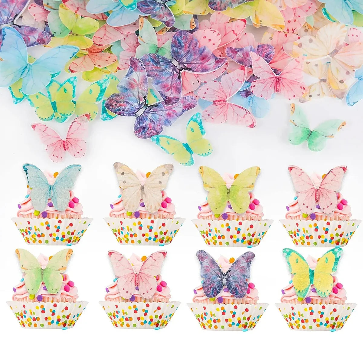 A collection of pink, blue, and yellow butterfly-shaped edible toppers decorating cupcakes.