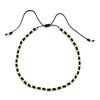 Handmade boho glass bead bracelet with adjustable cord featuring black and gold beads