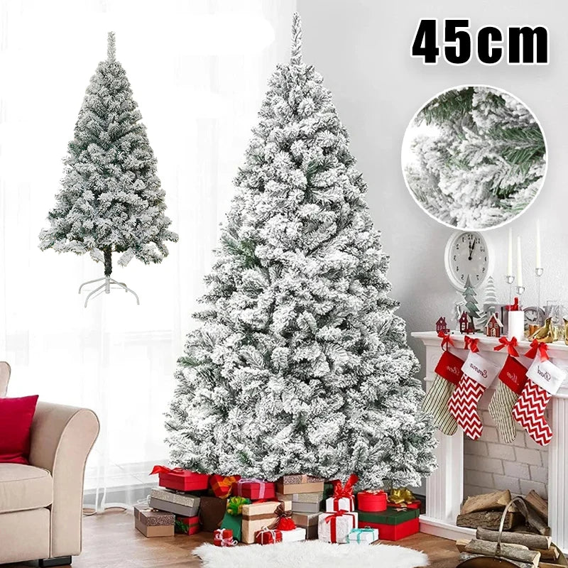 A large flocked artificial Christmas tree decorated with white snow, placed in a living room setting.