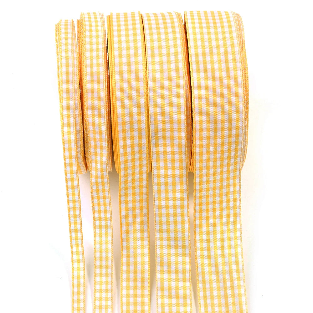A roll of yellow and white gingham ribbon used for gift wrapping, crafts, or party decor.