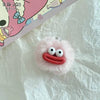 A pink fluffy plush keychain shaped like a sausage with an open mouth and white eyes.