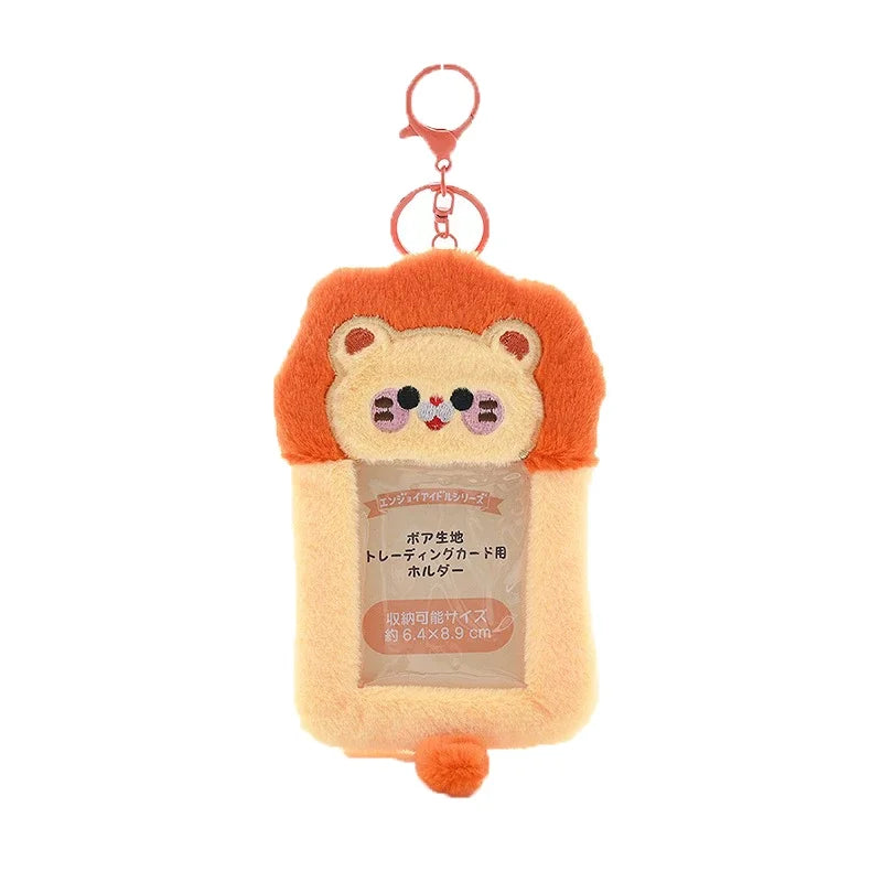 An orange and white fluffy cat-shaped keychain holder for Kpop photocards