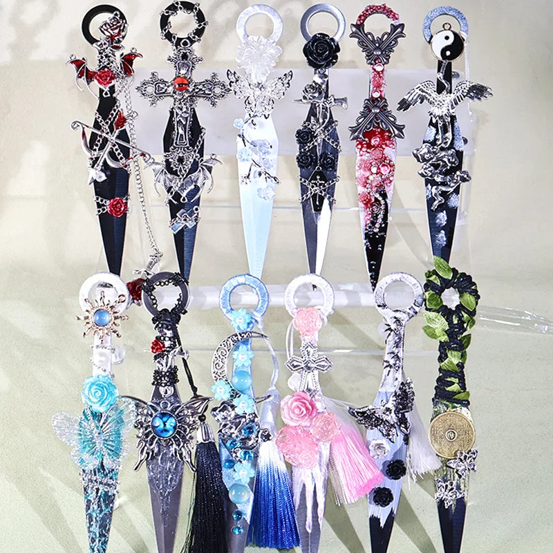 A collection of decorative gothic kunai utility knives featuring dark and iridescent blades and ornate silver and black handl