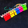A colorful plastic whistle set with various colored whistles attached to lanyards.