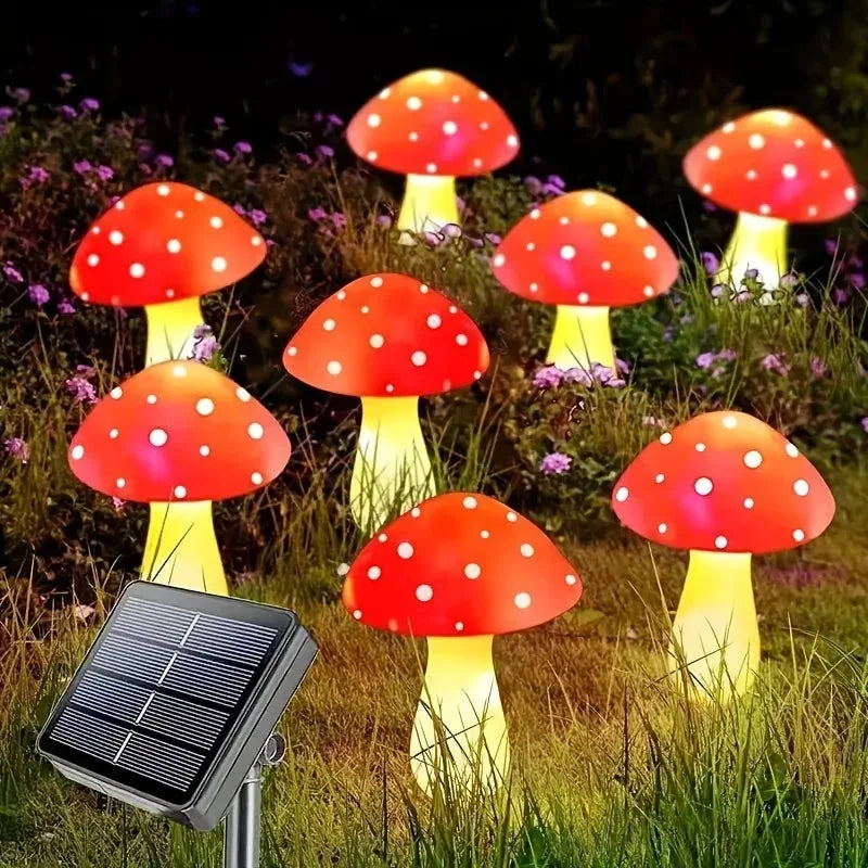 Six glowing red and white mushroom-shaped solar garden lights illuminating a grassy outdoor area.