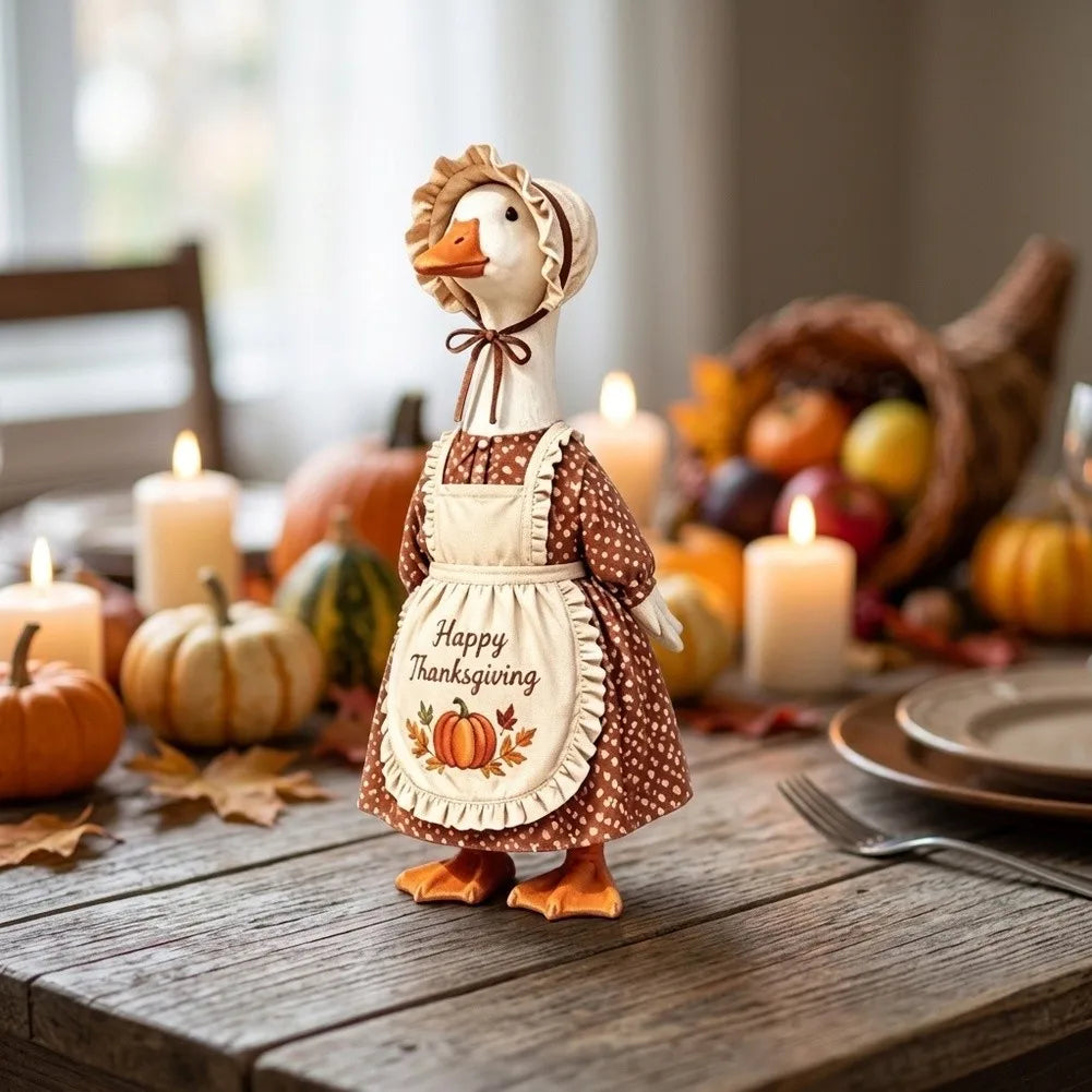 A handcrafted goose decoration wearing an apron and headband, set for autumn Thanksgiving decor.