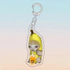 A yellow banana cat charm attached to a silver acrylic keychain ring.